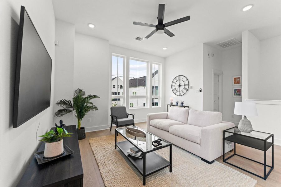 This thoughtfully designed two-story residence features a unique layout that places the living room, kitchen, and dining area on the second floor, creating a bright and airy space ideal for entertaining. Expansive windows flood the open-concept floor with natural light, while sleek finishes and modern fixtures add a touch of sophistication