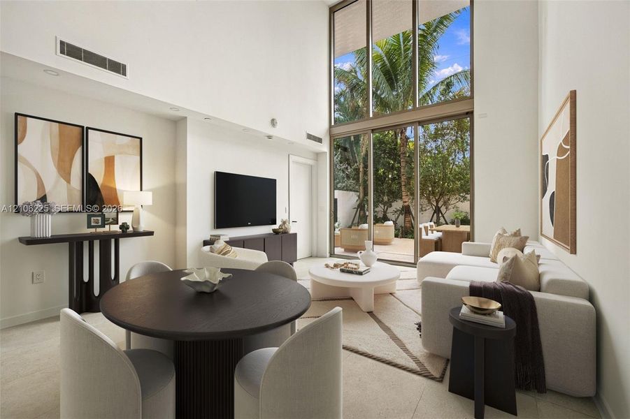 Double-height ceiling, floor-to-ceiling windows, sliding glass door, neutral stone-finish flooring, and recessed lighting Double-height ceiling, floor-to-ceiling windows, sliding glass door, neutral stone-finish flooring, and recessed lighting