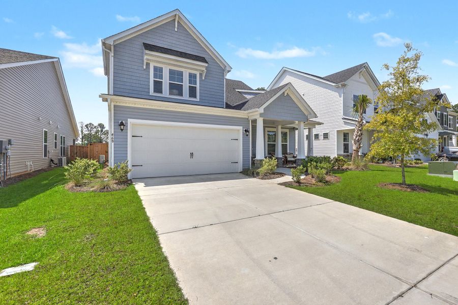 Front exterior of a new home in The Groves of Berkeley, Moncks Corner, SC, highlighting curb appeal (Image 1). Front exterior of a new home in The Groves of Berkeley, Moncks Corner, SC, highlighting curb appeal (Image 1).