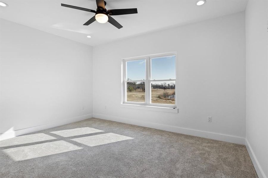 Spare room featuring recessed lighting, light colored carpet, baseboards, and ceiling fan Spare room featuring recessed lighting, light colored carpet, baseboards, and ceiling fan