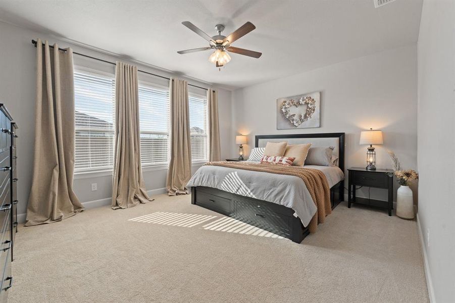 Bedroom featuring light colored carpet and ceiling fan