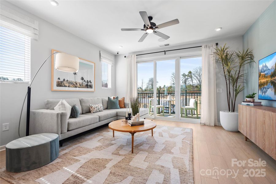 Great Room Featuring Ceiling Fan and Large Sliding Glass Doors.