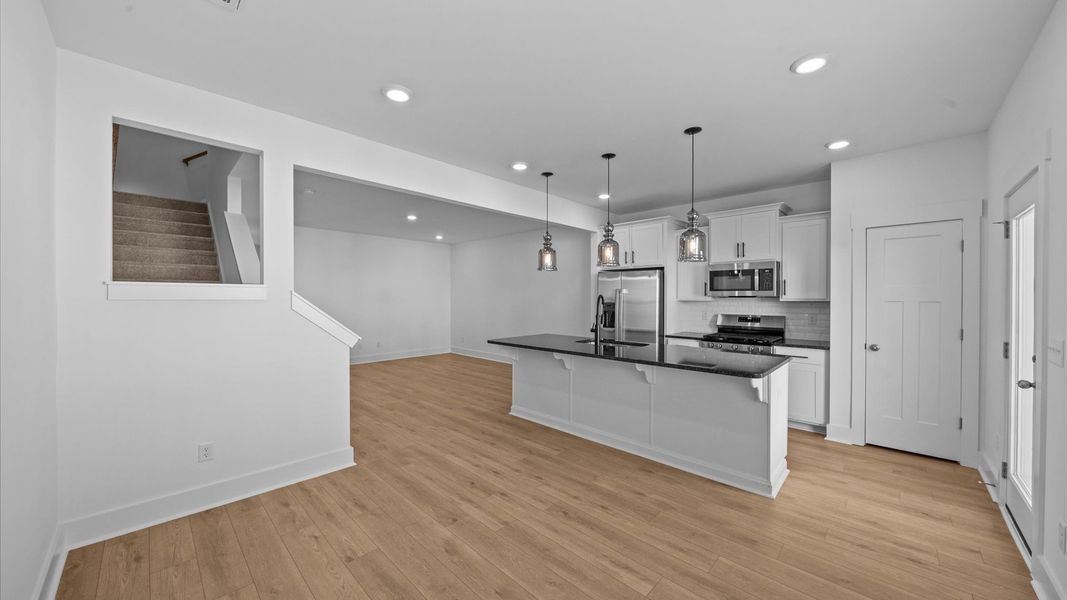 Exclusive DRB Homes kitchen with a 9-foot island, elevated finishes, and pendant lighting in a prime location Exclusive DRB Homes kitchen with a 9-foot island, elevated finishes, and pendant lighting in a prime location