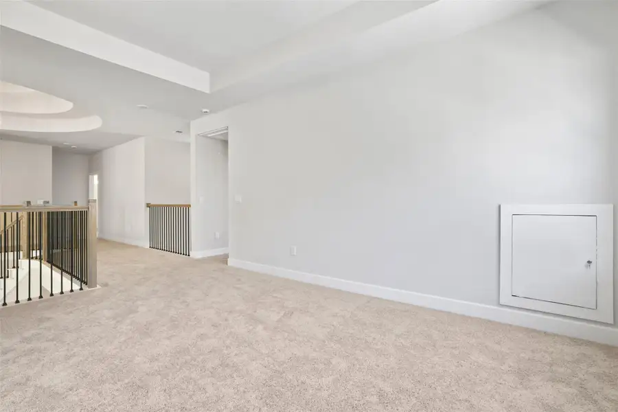 Unfurnished room with a raised ceiling and light colored carpet Unfurnished room with a raised ceiling and light colored carpet