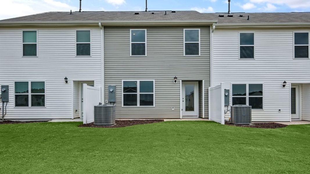 Exterior details and patio area of a home in The Townes at Hunter Hill, Rocky Mount (Image 25).