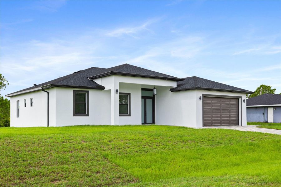 Front exterior of a new home in , Lehigh Acres, FL, highlighting curb appeal (Image 2).