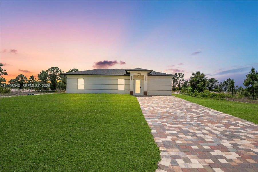 Front exterior of a new home in , Lehigh Acres, FL, highlighting curb appeal (Image 13).