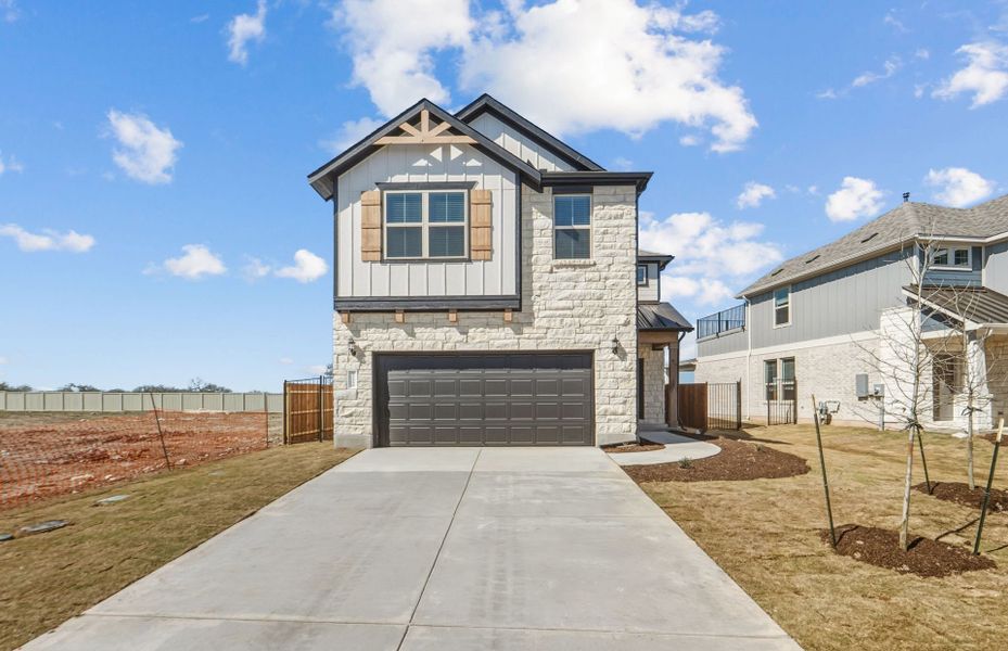 Front exterior of a new home in Santa Rita Ranch, Liberty Hill, TX, highlighting curb appeal (Image 23).