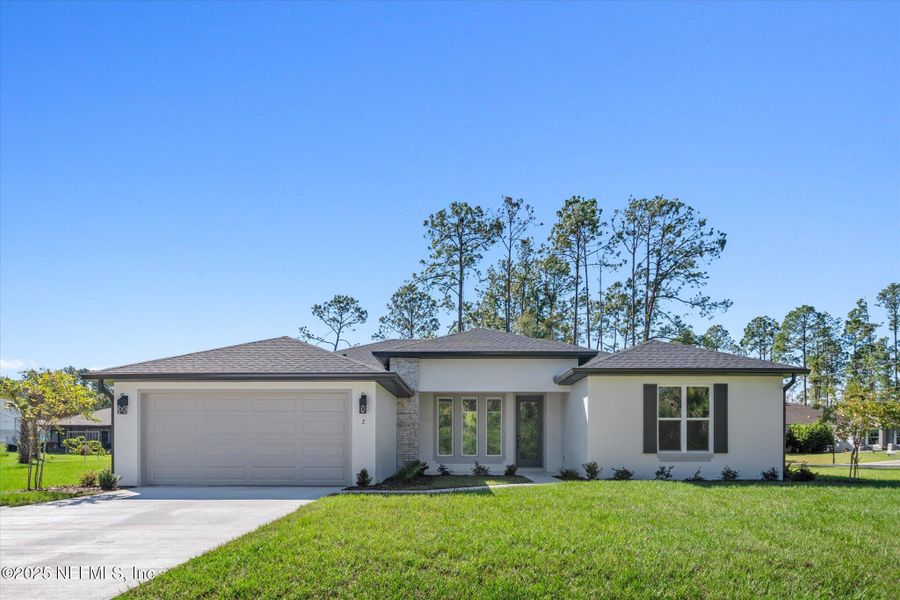 Front exterior of a new home in , Palm Coast, FL, highlighting curb appeal (Image 1). Front exterior of a new home in , Palm Coast, FL, highlighting curb appeal (Image 1).