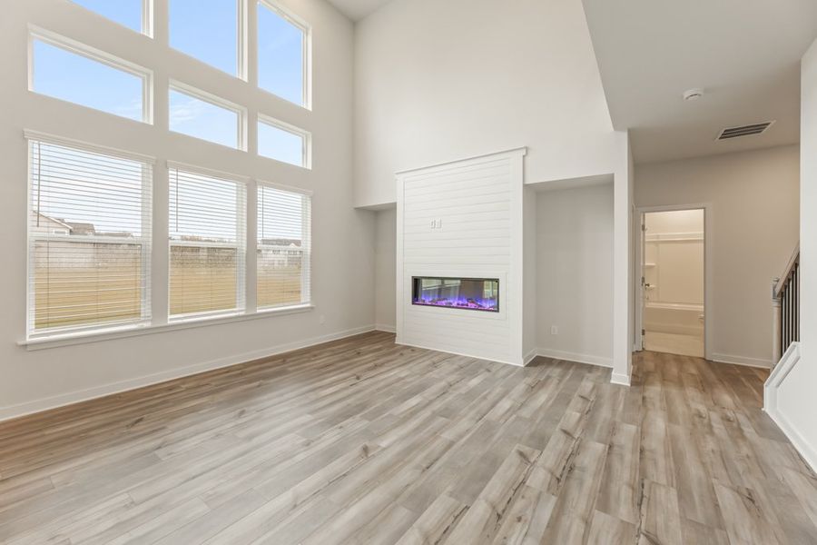 A room with a tv and a window. A room with a tv and a window.