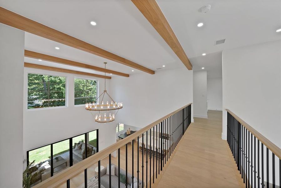 Vaulted ceiling with wood beams and recessed lighting