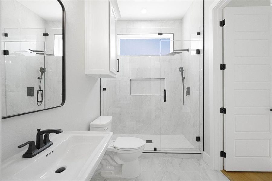 Bathroom featuring toilet and a shower stall