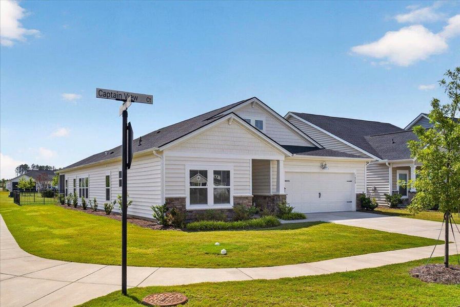 Front exterior of a new home in Horizons at Summers Corner | 55+, Summerville, SC, highlighting curb appeal (Image 2). Front exterior of a new home in Horizons at Summers Corner | 55+, Summerville, SC, highlighting curb appeal (Image 2).