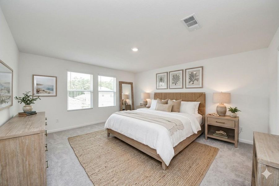 This airy virtually staged primary bedroom is found up.
