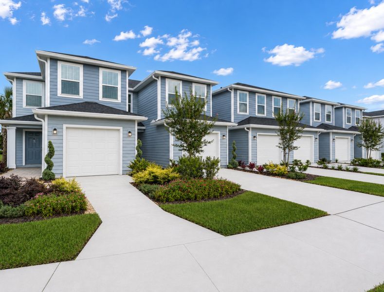 Front exterior of a new home in Oak Hill Village Townhomes, Jacksonville, FL, highlighting curb appeal (Image 1). Front exterior of a new home in Oak Hill Village Townhomes, Jacksonville, FL, highlighting curb appeal (Image 1).