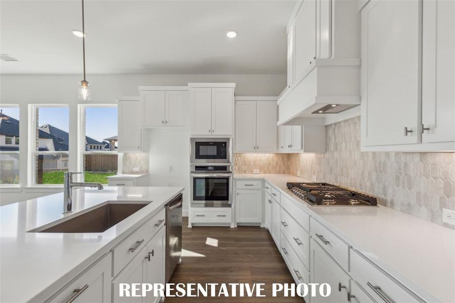 Gorgeous cabinetry, luxurious countertops and contemporary stainless appliances combine to create the kitchen of your dreams!  REPRESENTATIVE PHOTO