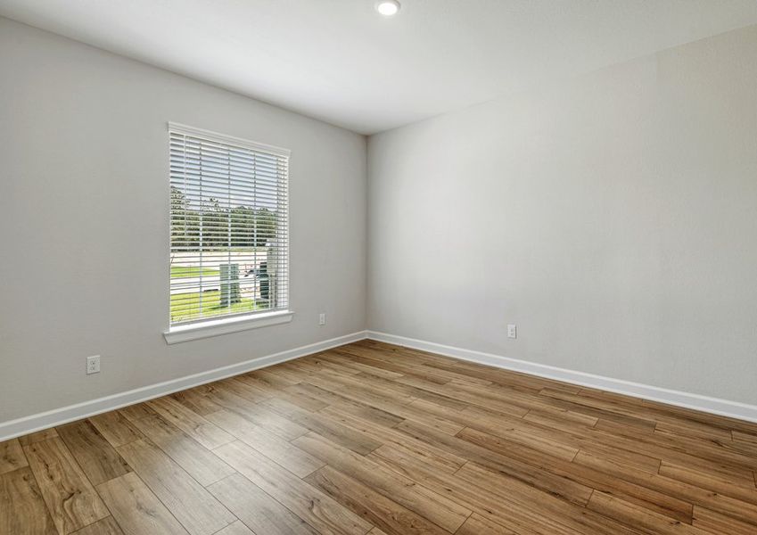 A separate dining room has a window with a front yard view