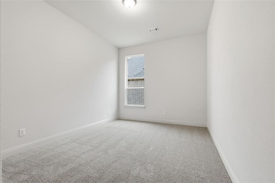Unfurnished room with light carpet and baseboards