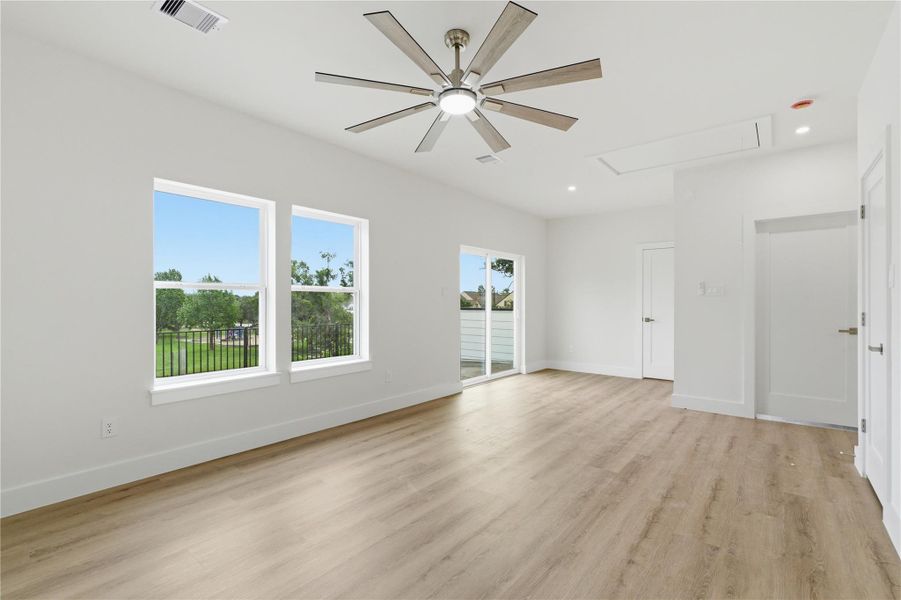A spacious third-floor flex area offers abundant natural light and direct balcony access, ideal for a game room, office, or additional living space.