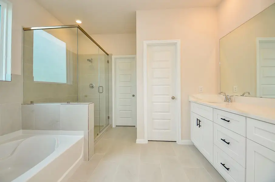 This spacious primary bathroom gives a spa ambiance. This spacious primary bathroom gives a spa ambiance.