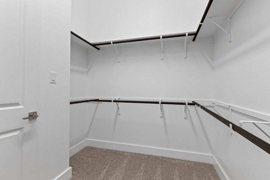 Walk-in closet in Primary Bedroom Walk-in closet in Primary Bedroom
