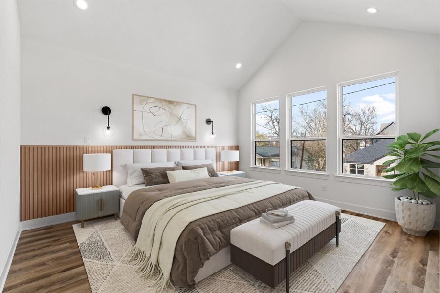Spacious primary bedroom with a modern accent wall, vaulted ceiling, and tons of natural light.