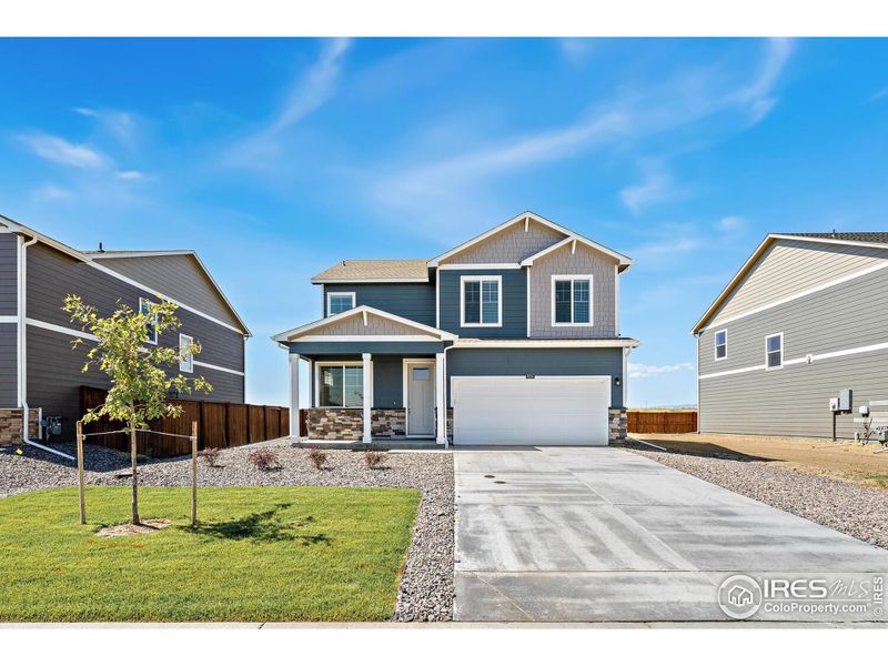 Front exterior of a new home in Westgate, Greeley, CO, highlighting curb appeal (Image 20).