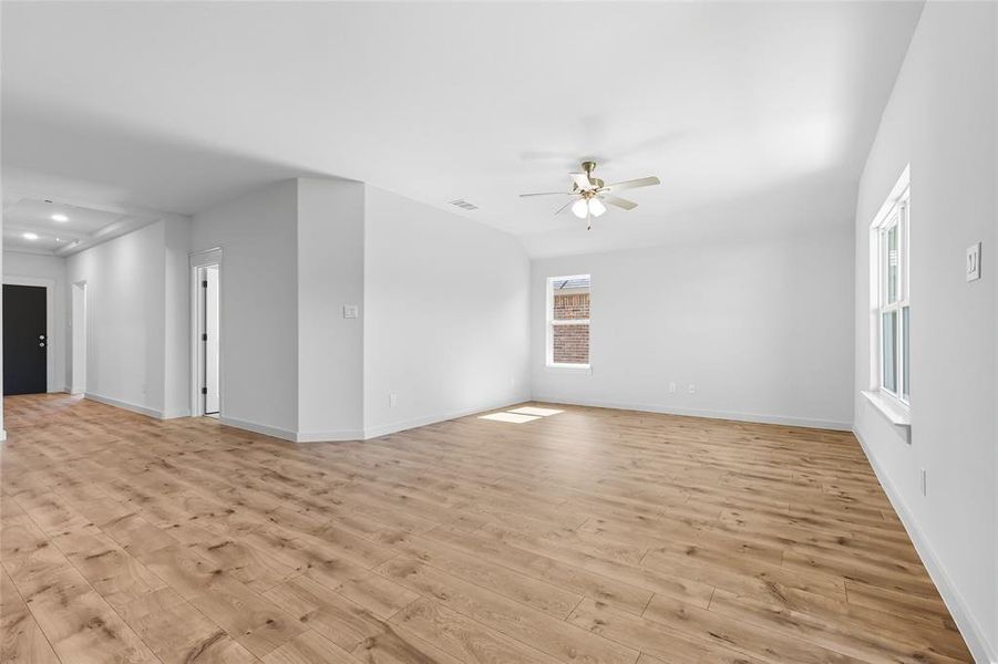 Empty room with light wood-type flooring, ceiling fan, and recessed lighting