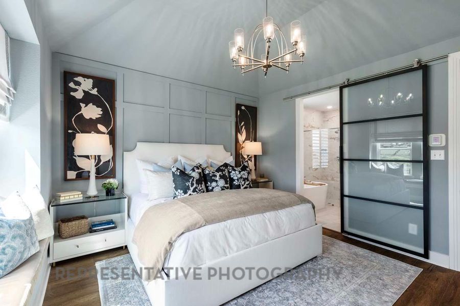 Bedroom featuring a chandelier, wood finished floors, and ensuite bathroom Bedroom featuring a chandelier, wood finished floors, and ensuite bathroom