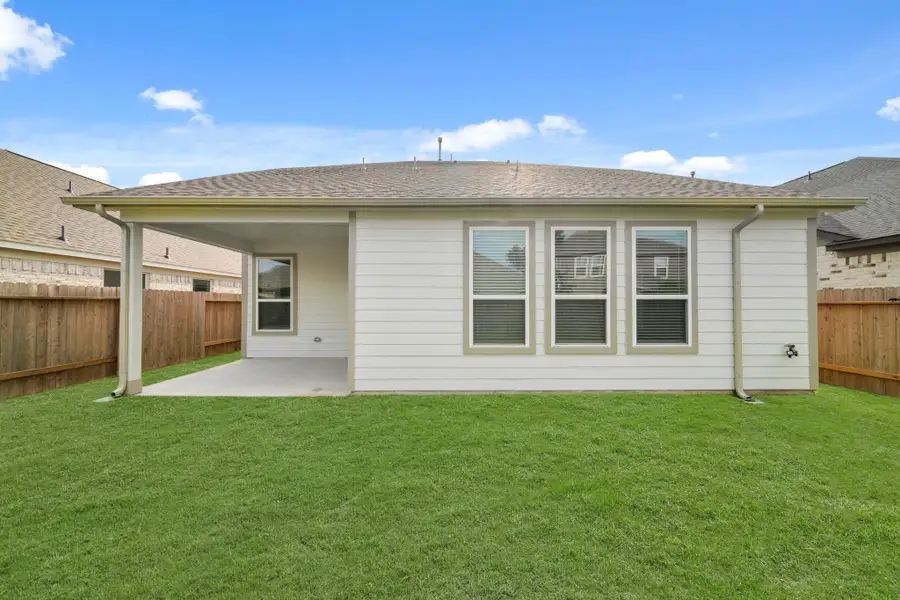Front exterior of a new home in Barton Creek Ranch, Conroe, TX, highlighting curb appeal (Image 2).