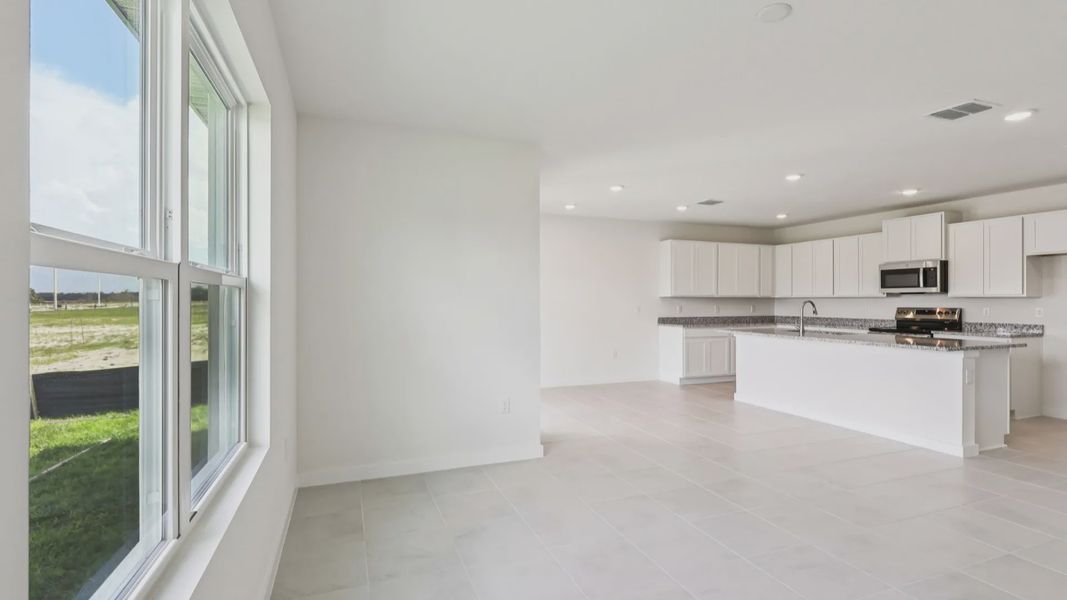 Dining Area and Kitchen of the Baker Floor Plan by DRB Homes in Liberty Trace New Homes in Haines City
