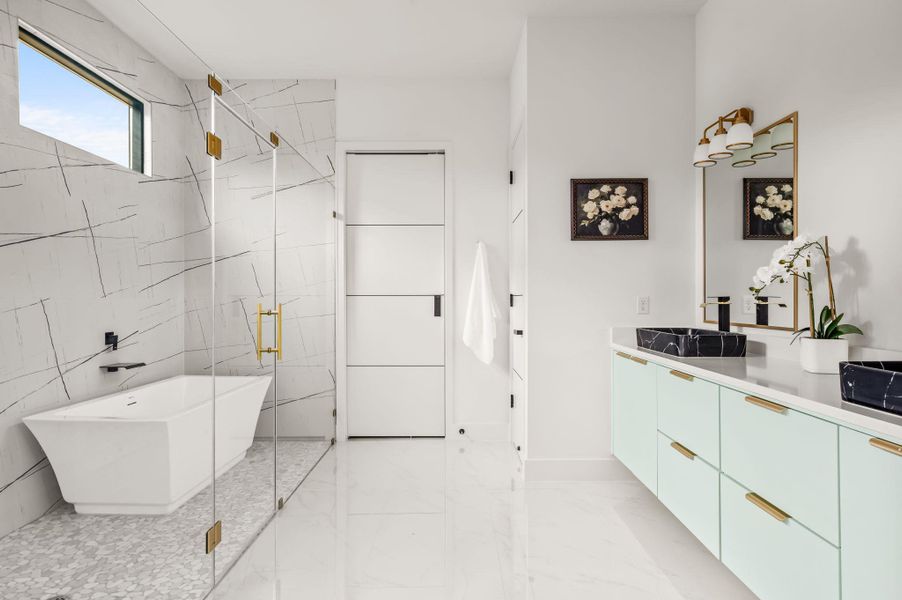 Indulge in a luxurious primary bathroom, featuring a freestanding tub within a glass-enclosed shower and a dual vanity with elegant vessel sinks. Indulge in a luxurious primary bathroom, featuring a freestanding tub within a glass-enclosed shower and a dual vanity with elegant vessel sinks.