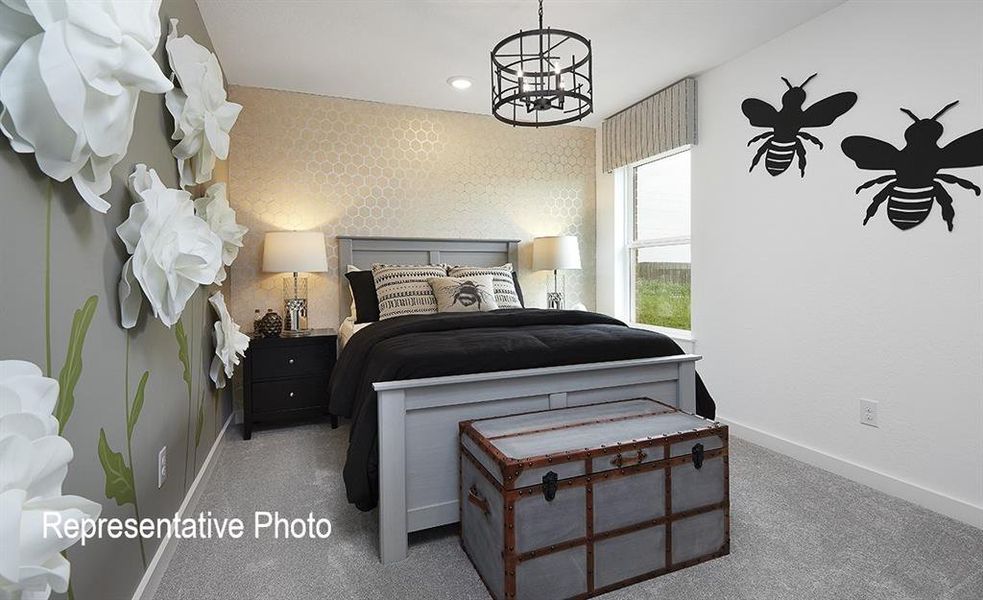 Carpeted bedroom featuring a window with striped valance, a ceiling-mounted light fixture, and textured wallpaper Carpeted bedroom featuring a window with striped valance, a ceiling-mounted light fixture, and textured wallpaper