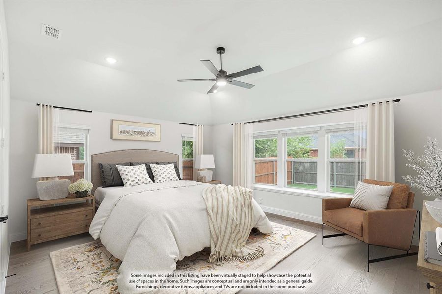 Bedroom with ceiling fan, light wood floors, large windows, and neutral decor including a queen bed and leather accent chair Bedroom with ceiling fan, light wood floors, large windows, and neutral decor including a queen bed and leather accent chair