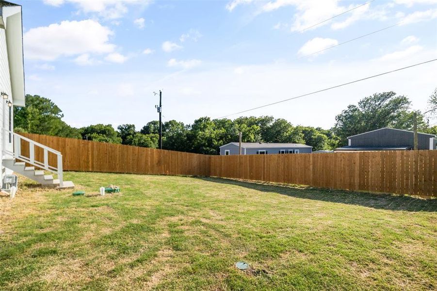 View of fenced backyard