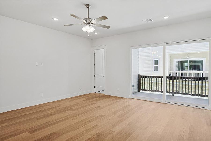 Empty room with ceiling fan and light wood-type flooring Empty room with ceiling fan and light wood-type flooring