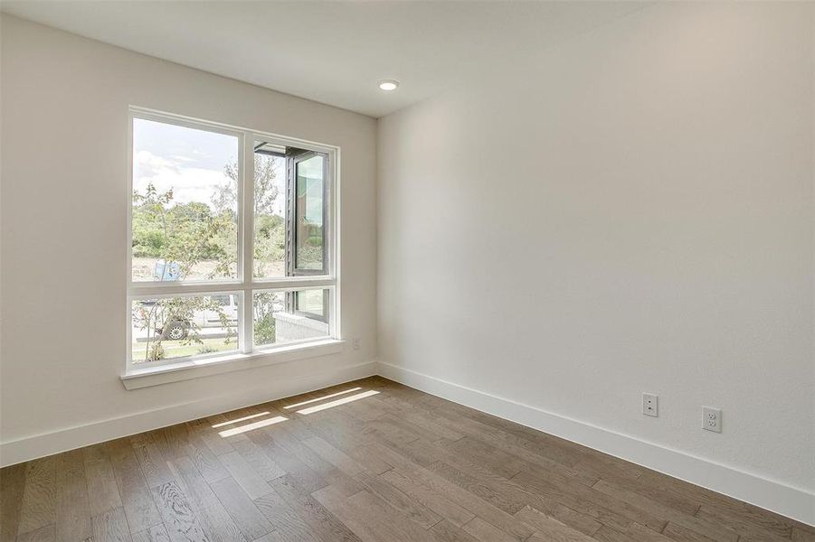 Empty room with dark wood-type flooring