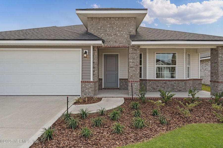 Front exterior of a new home in Shadow Crest at Rolling Hills, Green Cove Springs, FL, highlighting curb appeal (Image 14). Front exterior of a new home in Shadow Crest at Rolling Hills, Green Cove Springs, FL, highlighting curb appeal (Image 14).