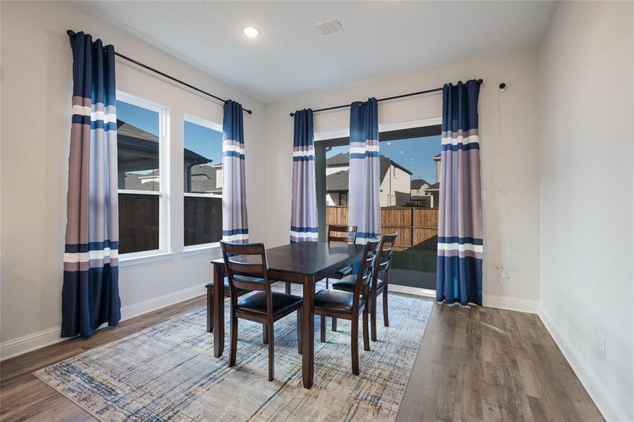 Beautiful windows surround the dining area in beautiful natural light.