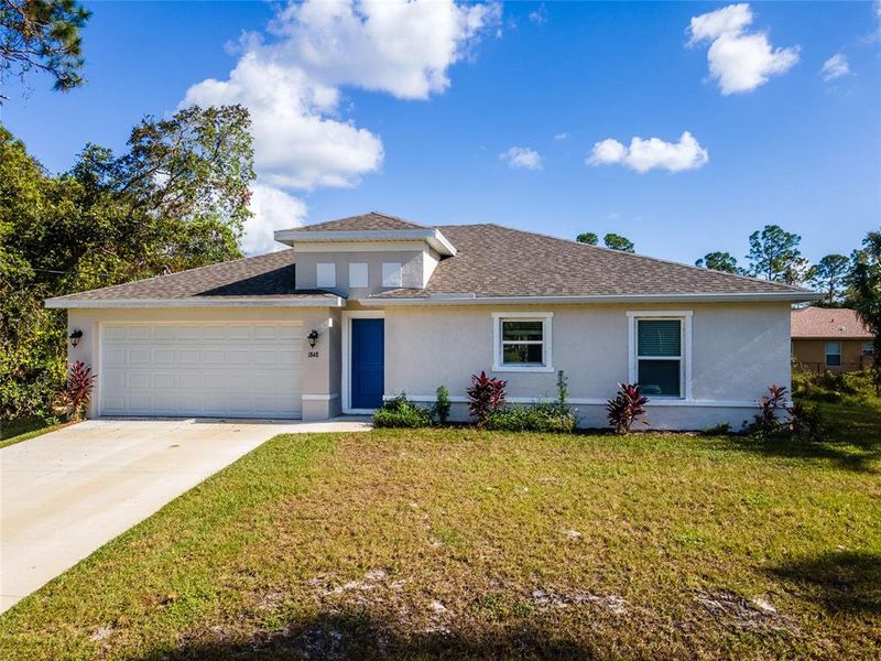 Front exterior of a new home in , North Port, FL, highlighting curb appeal (Image 1). Front exterior of a new home in , North Port, FL, highlighting curb appeal (Image 1).