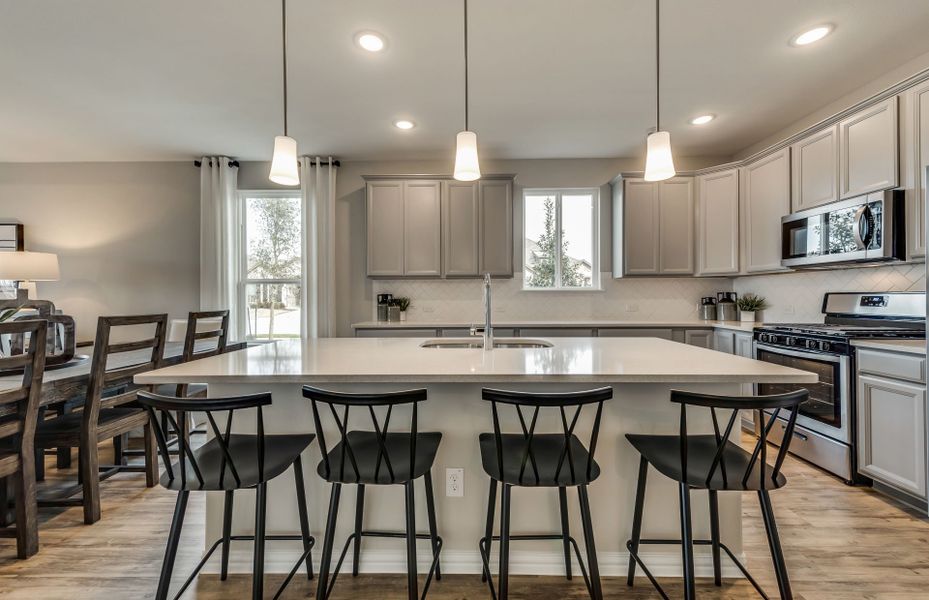 Gorgeous kitchen with recessed and pendant lighting