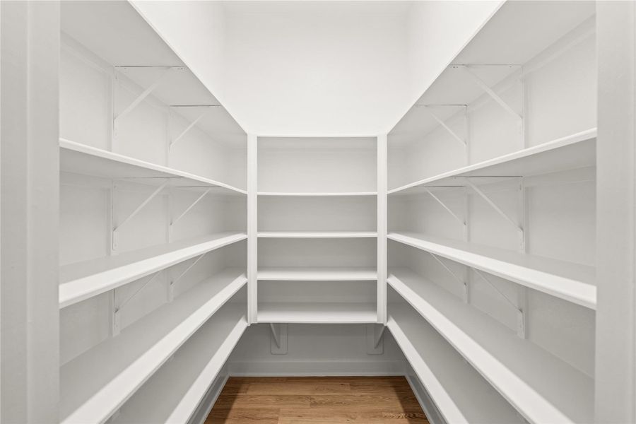 Spacious walk-in pantry with ample shelving for organized storage. Create your Pinterest worthy pantry space.