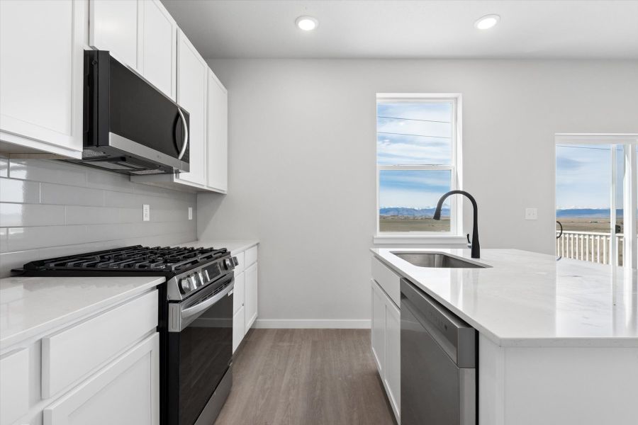 A kitchen with white cabinets. A kitchen with white cabinets.