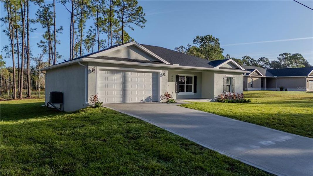 Front exterior of a new home in , Deltona, FL, highlighting curb appeal (Image 14).