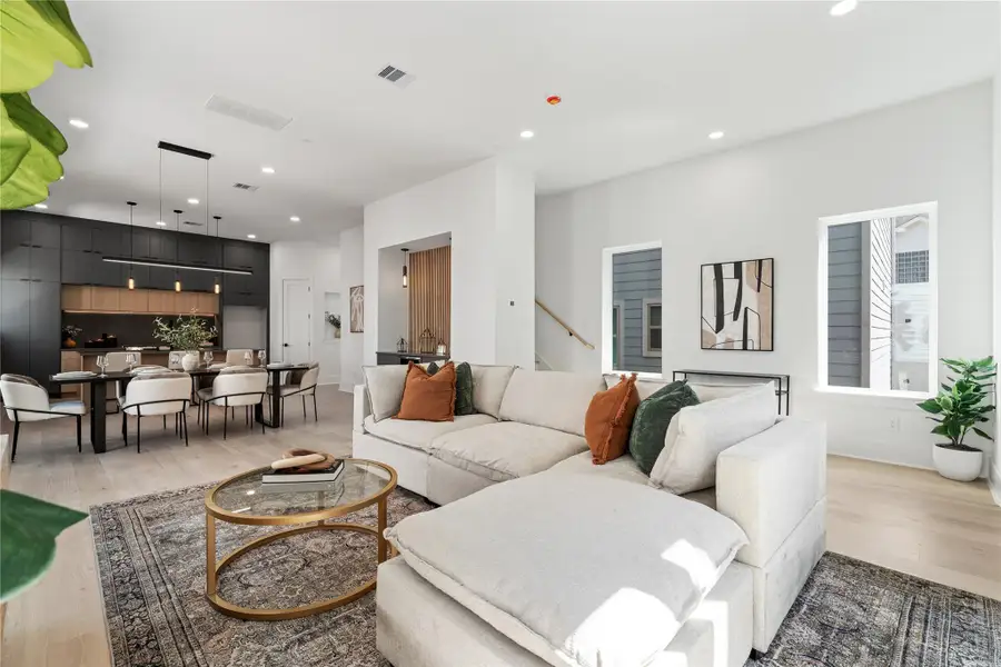 Bathed in natural light, this open-concept layout harmoniously blends the living, dining, and kitchen areas into one cohesive space. Layered textures, warm wood tones, and modern accents create an inviting atmosphere that’s equal parts stylish and functional—perfect for gathering, relaxing, or entertaining with ease. Bathed in natural light, this open-concept layout harmoniously blends the living, dining, and kitchen areas into one cohesive space. Layered textures, warm wood tones, and modern accents create an inviting atmosphere that’s equal parts stylish and functional—perfect for gathering, relaxing, or entertaining with ease.