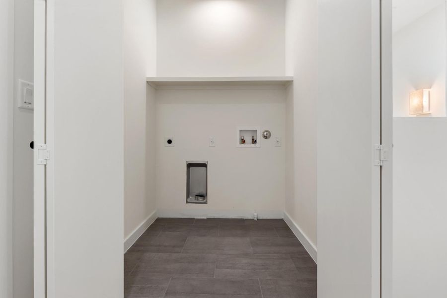 The dedicated laundry room provides a convenient and functional space for everyday household tasks. The dedicated laundry room provides a convenient and functional space for everyday household tasks.