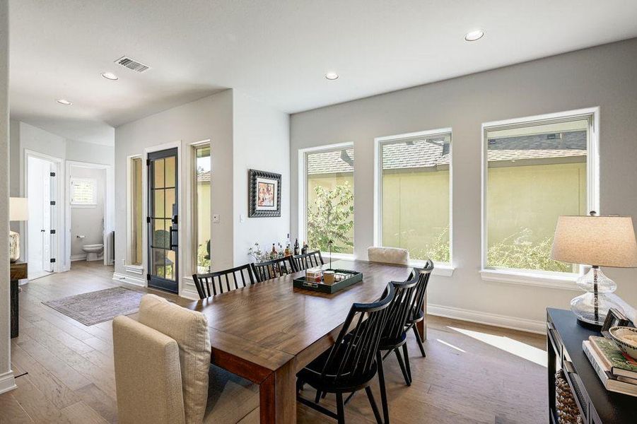 Dining room featuring hardwood / wood-style floors and recessed lighting Dining room featuring hardwood / wood-style floors and recessed lighting