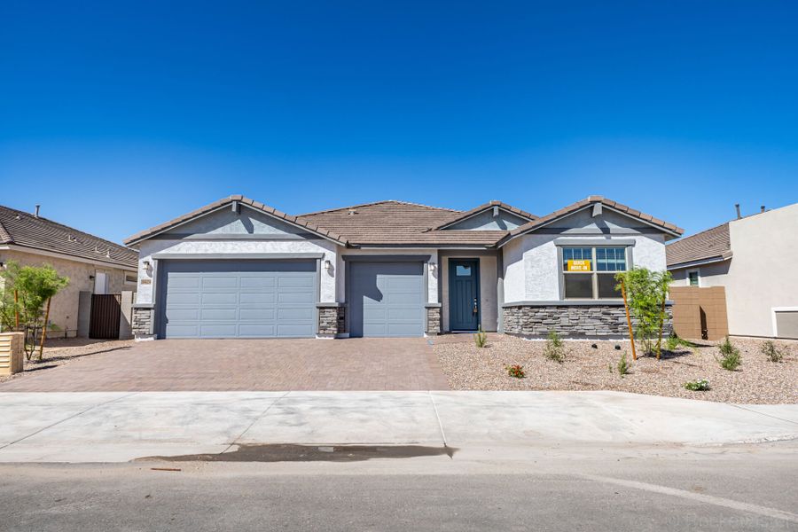 Front exterior of a new home in Las Ventanas, Goodyear, AZ, highlighting curb appeal (Image 1). Front exterior of a new home in Las Ventanas, Goodyear, AZ, highlighting curb appeal (Image 1).