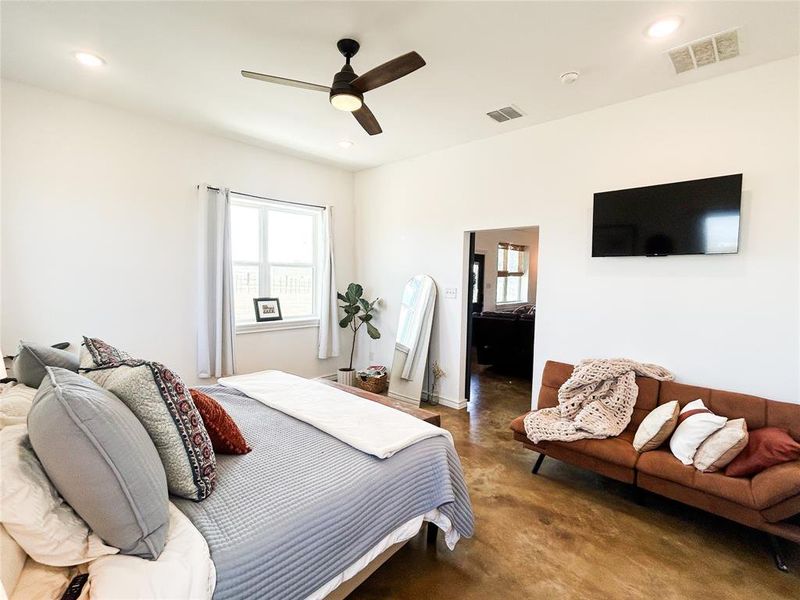 Bedroom with finished concrete flooring, recessed lighting, and ceiling fan Bedroom with finished concrete flooring, recessed lighting, and ceiling fan