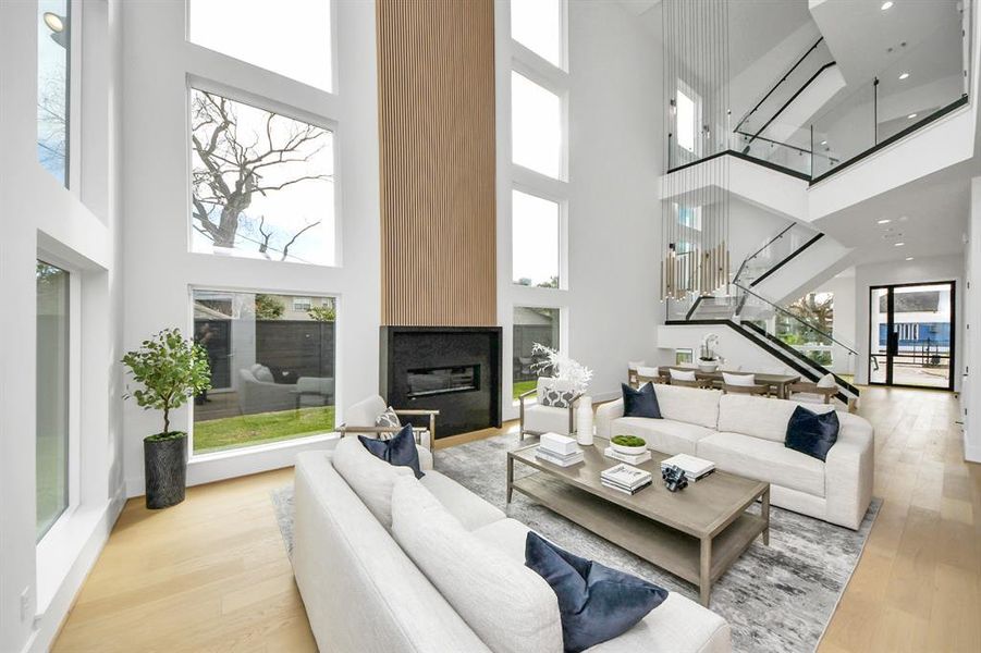 The open floor plan seamlessly connects to the dining area and staircase, enhancing the modern, airy ambiance.